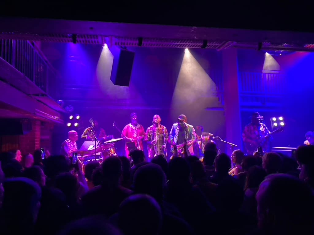 Band playing under warm stage lights